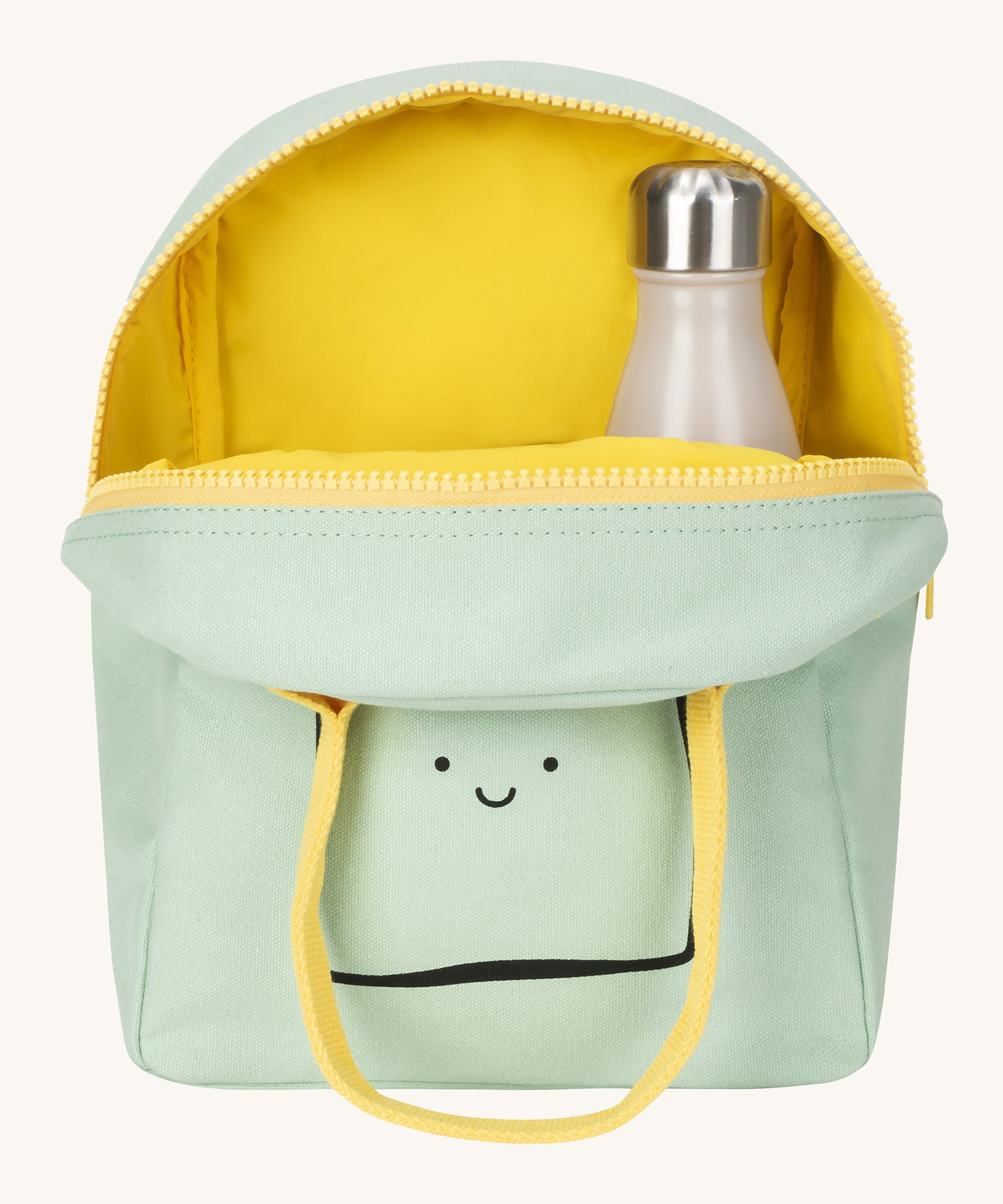 Fluf zip lunch bag in light green showing the yellow inner. Lunch bag has a playful black outline design of a slice of bread with a light yellow handle and zip detail