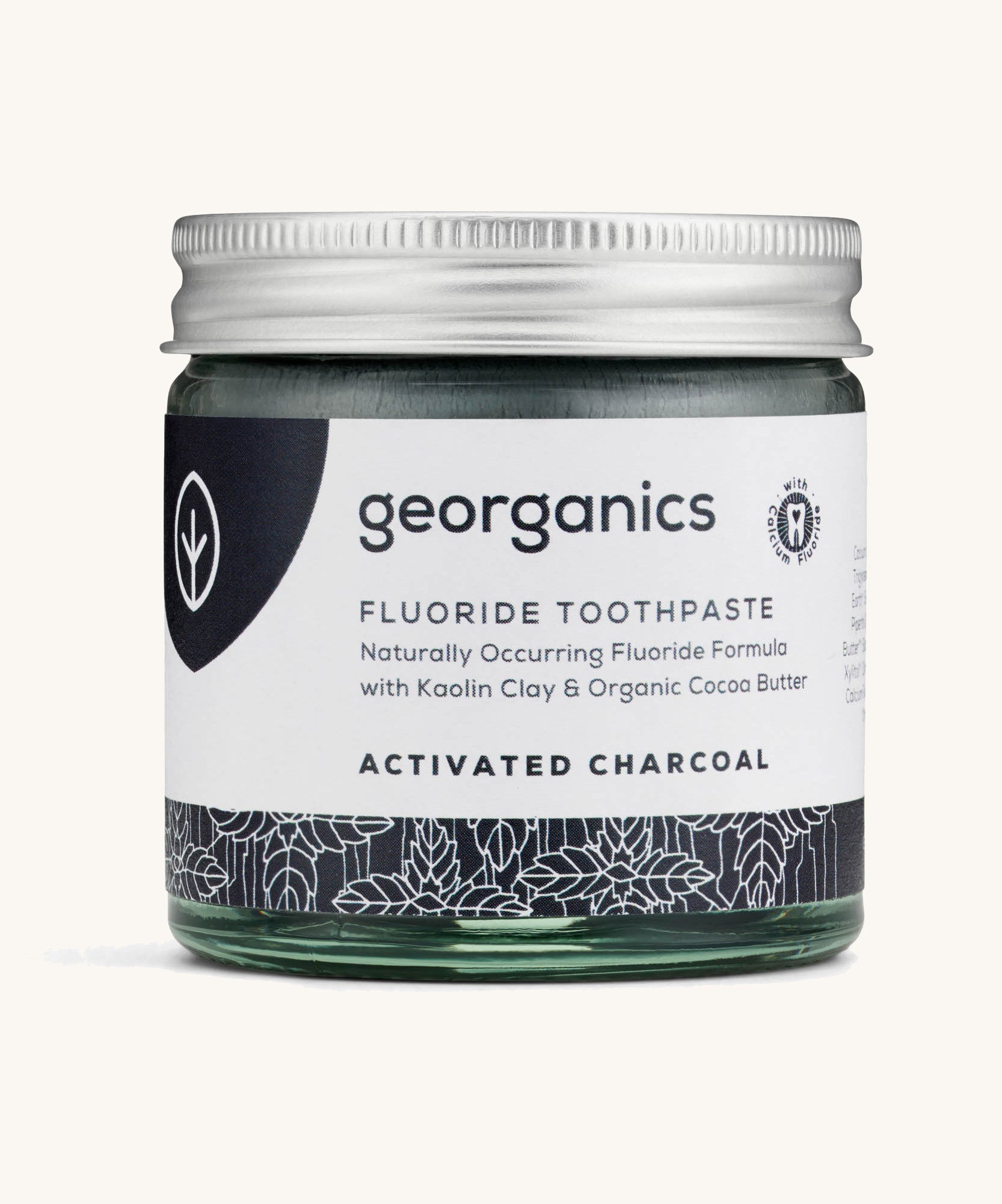 A jar of the Georganics activated fluoride toothpaste on a cream background