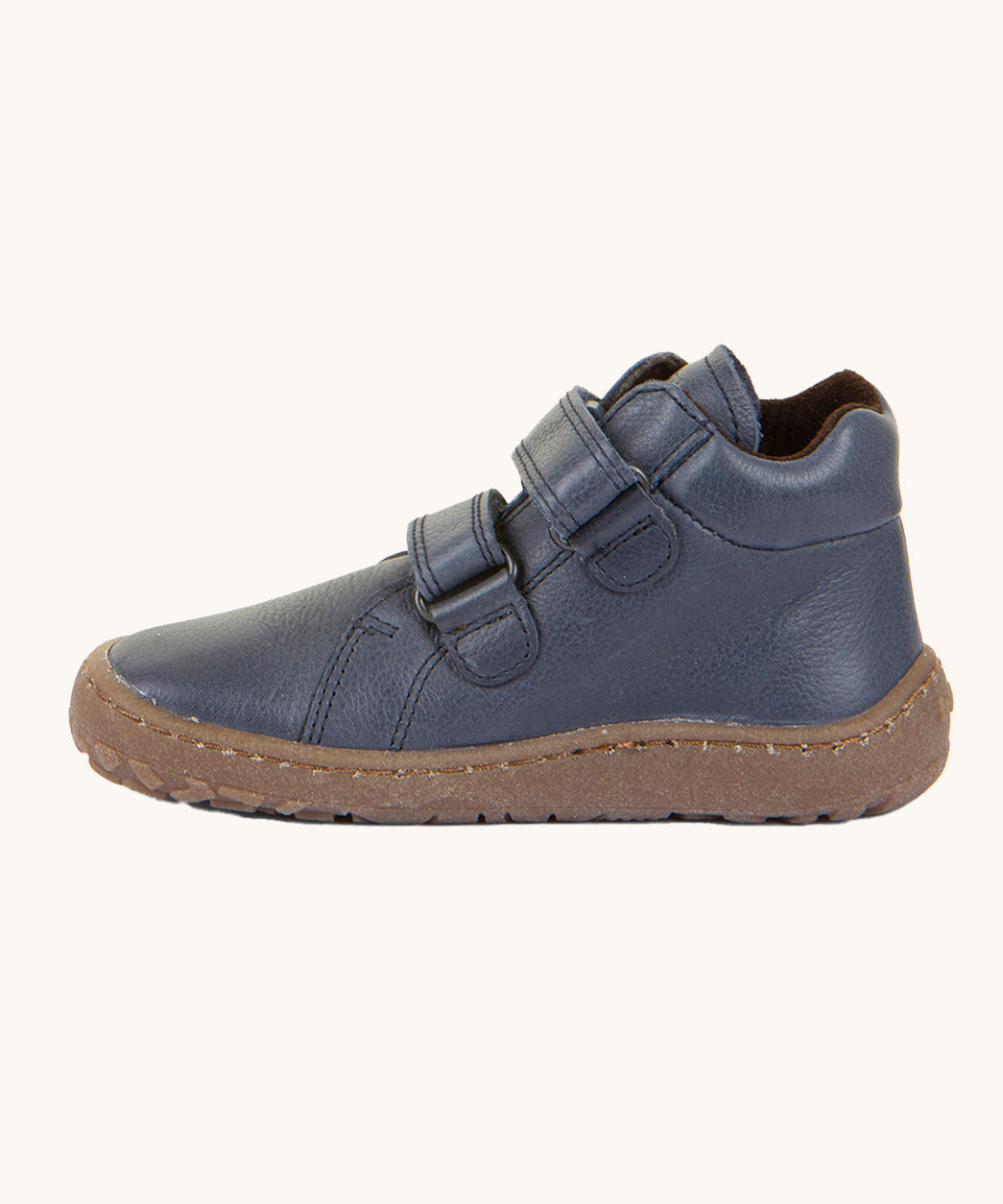 A side image of a Froddo barefoot Autumn children's shoe in navy available at Babipur showing the 2 velcro fastener for a secure fit, padded ankle and the dark brown grippy sole