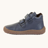 A side image of a Froddo barefoot Autumn children's shoe in navy available at Babipur showing the 2 velcro fastener for a secure fit, padded ankle and the dark brown grippy sole