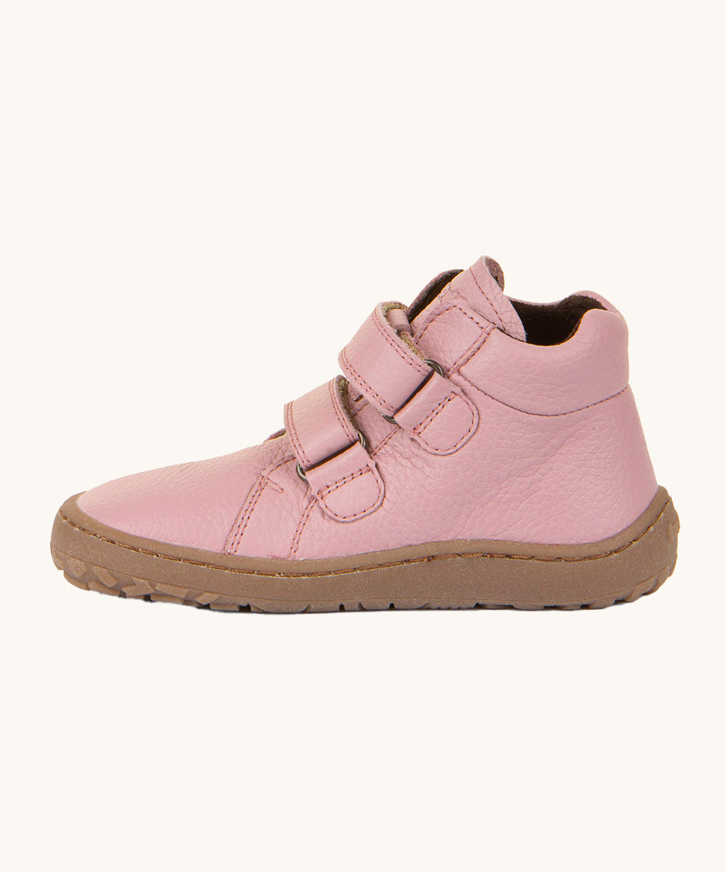 A side image of a Froddo barefoot Autumn children's shoe in pink available at Babipur showing the 2 velcro fastener for a secure fit, padded ankle and the dark brown grippy sole