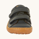 The front of the Froddo barefoot base children's shoe in navy available at Babipur. showing the 2 velcro fasteners and the brown grippy sole detail