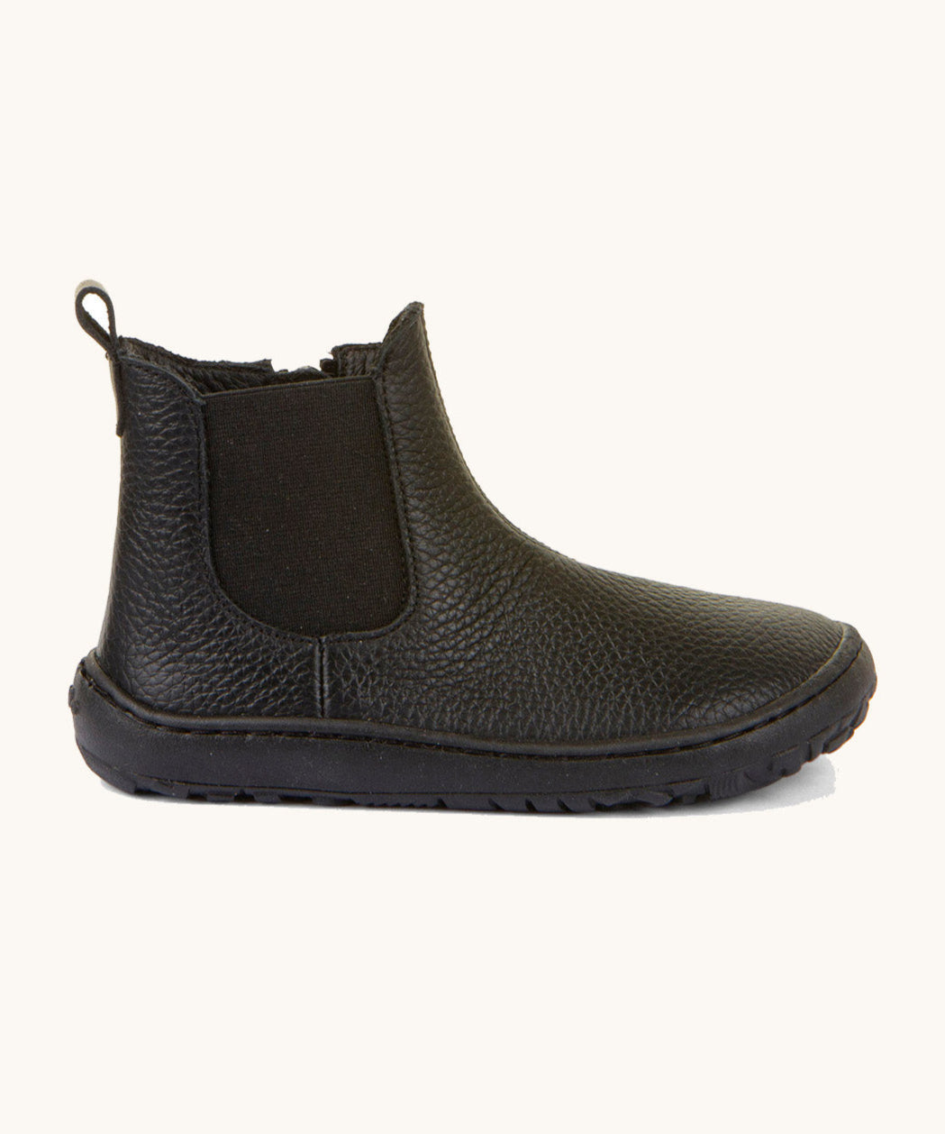 A side image of the Froddo barefoot kids leather school chelsea boots available at Babipur showing the side elastic and matching black sole detail