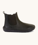 A side image of the Froddo barefoot kids leather school chelsea boots available at Babipur showing the side elastic and matching black sole detail