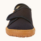 The front of the Froddo barefoot kids slipper in dark blue available at Babipur. showing the velcro strap and grippy sole detail