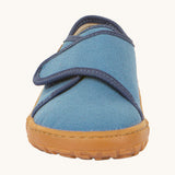 The front of the Froddo barefoot kids slipper in denim blue available at Babipur. showing the velcro strap and grippy sole detail