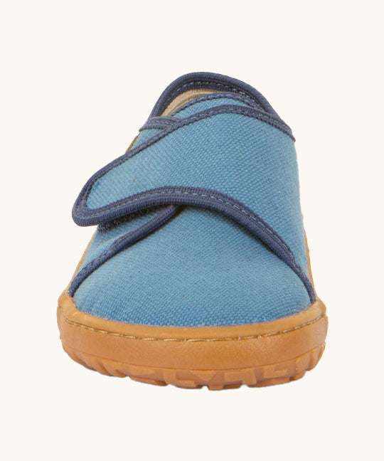 The front of the Froddo barefoot kids slipper in denim blue available at Babipur. showing the velcro strap and grippy sole detail