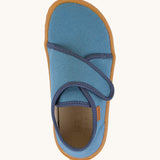 A top down image of the Froddo barefoot kids slipper in denim blue available at Babipur. showing the velcro strap and insole detail