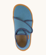 A top down image of the Froddo barefoot kids slipper in denim blue available at Babipur. showing the velcro strap and insole detail