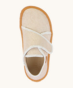 A top down image of the Froddo barefoot kids slipper in gold shine available at Babipur. showing the velcro strap and insole detail
