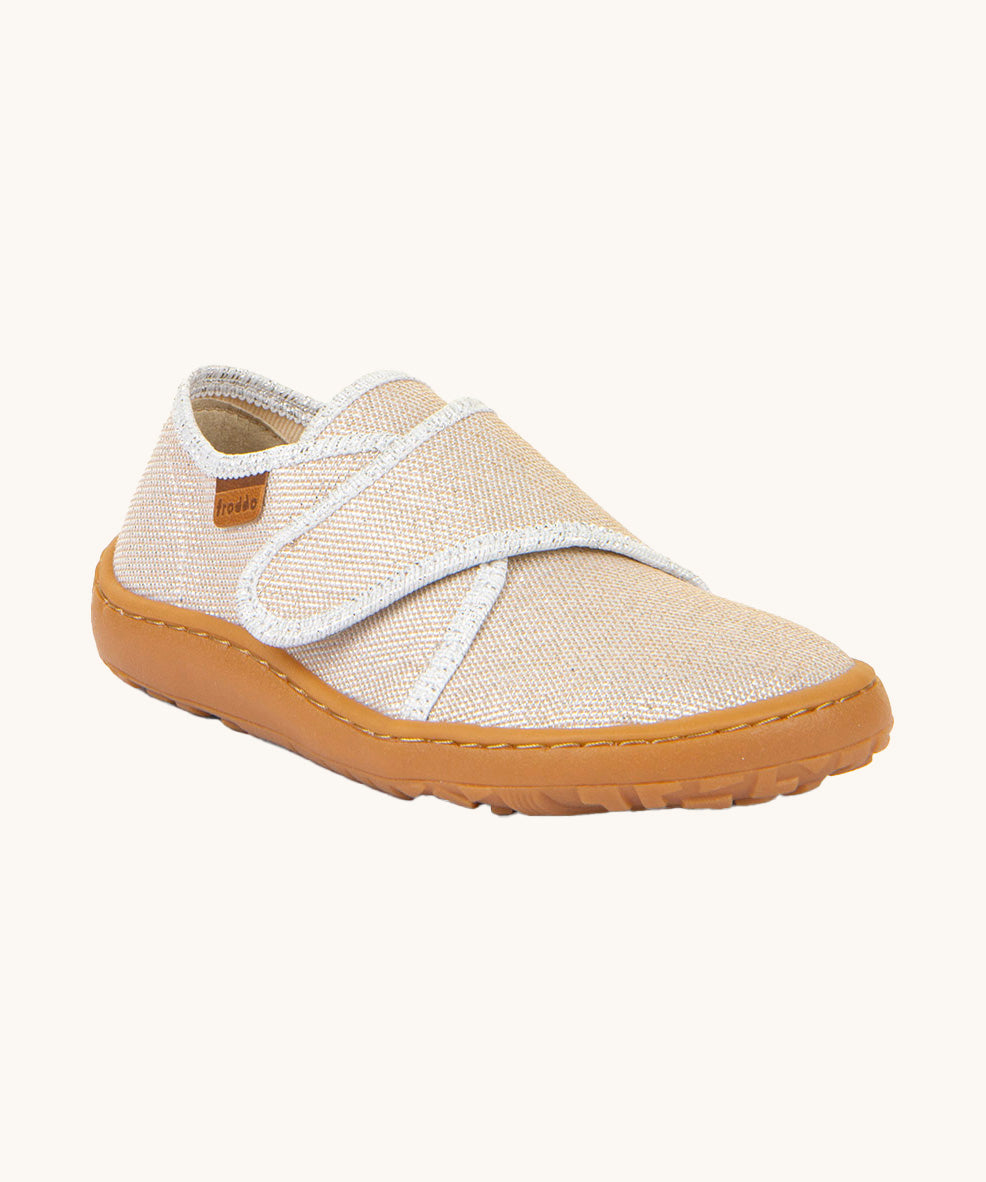 Froddo barefoot kids slipper in gold shine available at Babipur. A canvas style slipper shoe in a light neutral colour with a velcro fastener for a secure fit and a dark brown grippy sole