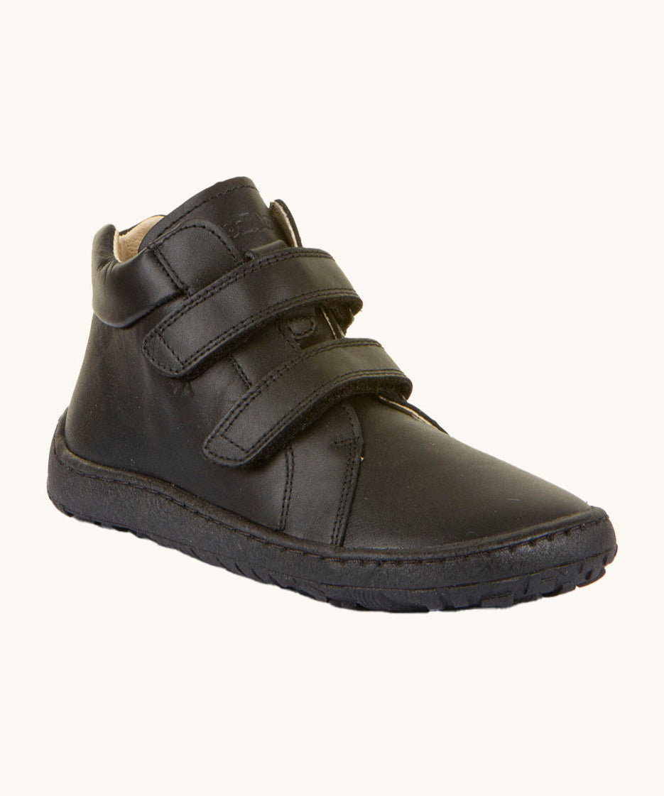 Froddo barefoot leather school boots in black available at Babipur. A ankle high soft leather boot with a matching black rubber sole. Features 2 velcro strap for.a secure fit and a padded ankle