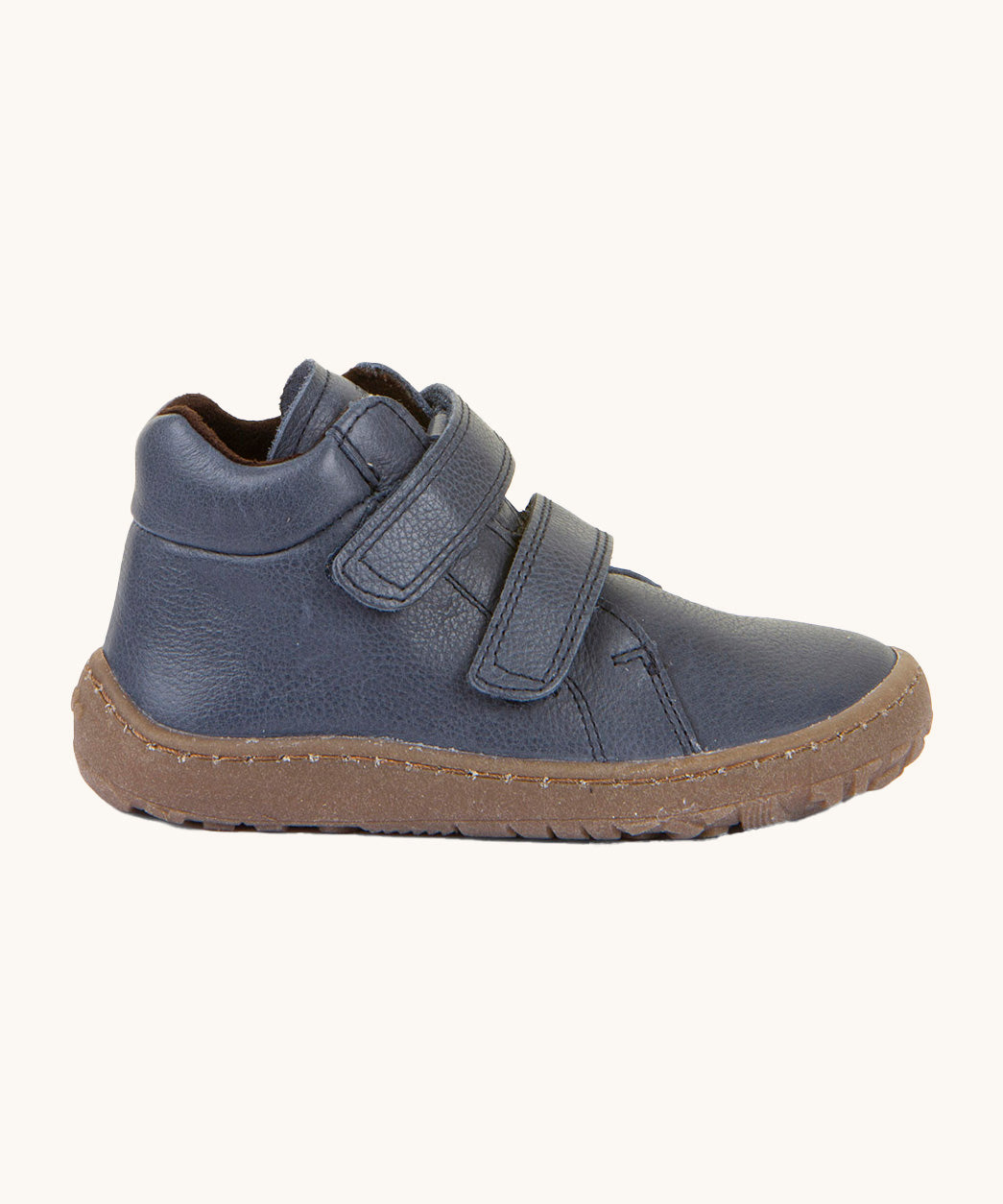 A side image of a Froddo barefoot Autumn children's shoe in navy available at Babipur showing the 2 velcro fastener padded ankle support and the dark brown grippy sole detail