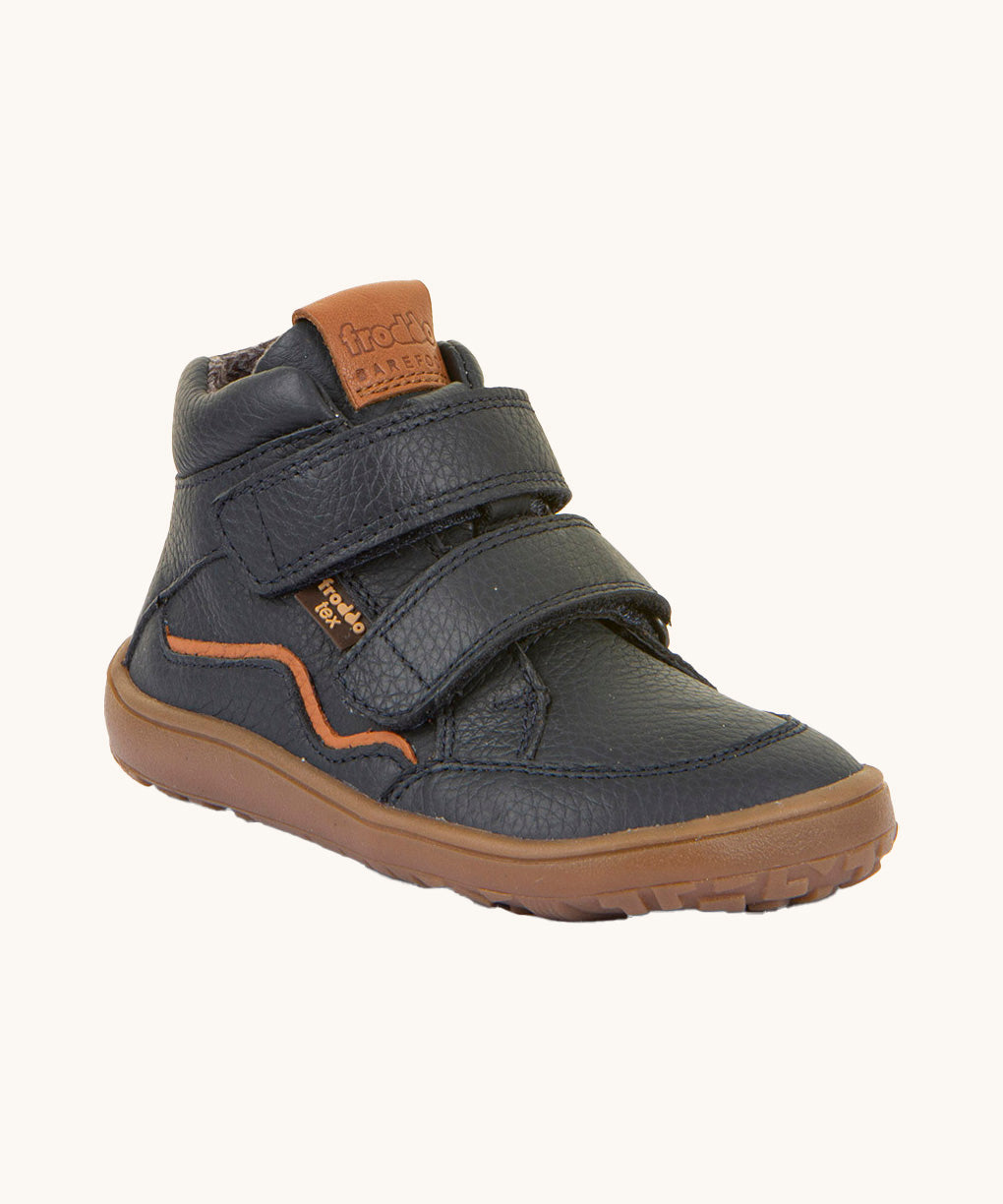 Froddo barefoot tex kids autumn shoes in navy available at Babipur. A soft ankle high shoe in navy with a light brown rubber sole. Features two velcro straps for a secure fit