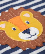 A close up of the lion's head applique on the Frugi discovery applique top in stripe/Lion available at Babipur