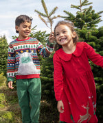 2 children playing in the woods. A boy is wearing the the Frugi forest fairisle/yeti jumper and the girl is wearing the red robin reindeer cord dress.  Both are GOTS organic cotton garments and available at Babipur.