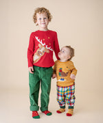 A boy wearing the Frugi Berry Red Reindeer Terrific Circular Organic Cotton long sleeved kids top standing next to a small child wearing the gold stripe robin appliqué top. These tops are both available at Babipur.