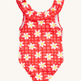 Frugi kids coral swim suit in check and daisy chain design on a cream background.