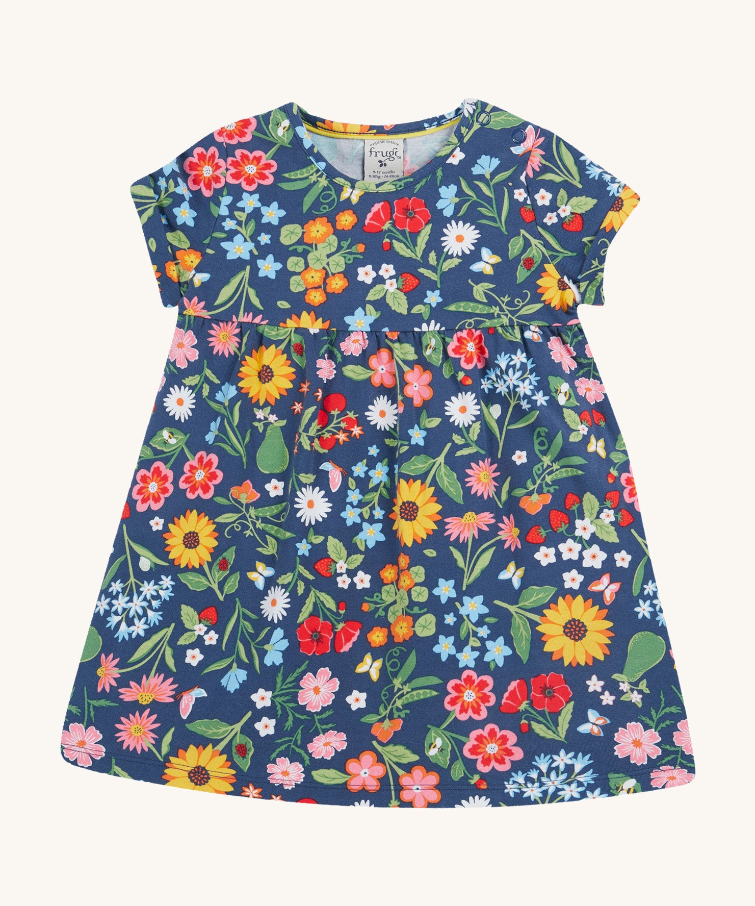 Frugi navy dress potager garden design on a cream background.