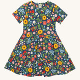 Frugi navy skater dress potager garden design on a cream background.