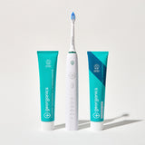 Georganics fluoride free toothpaste with pre and prebiotcs in fresh mint flavour available at Babipur standing next to a Georganics sonic toothbrush and fresh mint toothpaste with fluoride