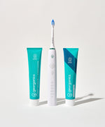 Georganics fluoride free toothpaste with pre and prebiotcs in fresh mint flavour available at Babipur standing next to a Georganics sonic toothbrush and fresh mint toothpaste with fluoride