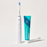 Georganics fluoride free toothpaste with pre and prebiotcs in fresh mint flavour available at Babipur standing next to a Georganics sonic toothbrush
