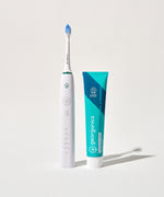 Georganics fluoride free toothpaste with pre and prebiotcs in fresh mint flavour available at Babipur standing next to a Georganics sonic toothbrush