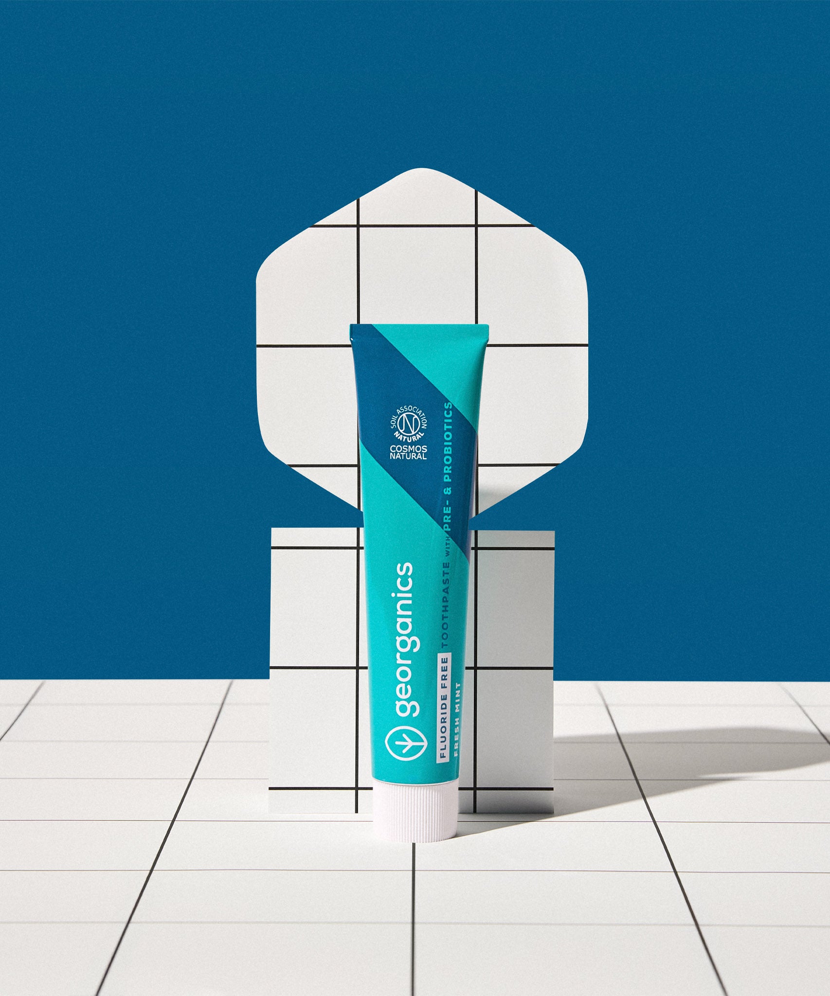 Georganics fluoride free toothpaste with pre and prebiotcs in fresh mint flavour available at Babipur with a retro white and blue background