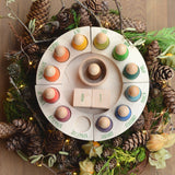 Grapat Perpetual Calendar, a beautiful winter display with a pine-cone wreath surrounding the outside of the calendar.