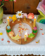A beautiful Grimm's Celebration Ring with cream coloured Grimm's candles in candle holders, along with pretty Grimm's decorative figures make up a wonderful Sprint time display