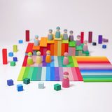 The Grimm's 12 Pastel Friends stood on top of colourful Grimm's wooden Leonardo Sticks