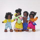 The Grimm's Handmade Waldorf Doll Family includes Mr Ebony, Mrs Ebony, Lisa, Max and Baby Sam. The dolls are all stood together with Mrs Ebony holding baby Max