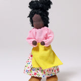Grimm's Handmade Doll - Mrs Ebony is stood upright with its arm bent at the elbows towards its middle. The image is on a light grey background