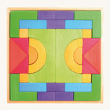 Grimm's Basic Building Set is a set of colourful wooden blocks in different shapes and sizes, in a wooden tray.