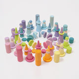 The Grimm's 12 Pastel Friends used in an open ended play scene with other wooden Grimm's Pastel pieces