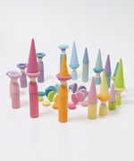 The Grimm's 12 Pastel Friends used in a play scene with other wooden Grimm's Pastel pieces