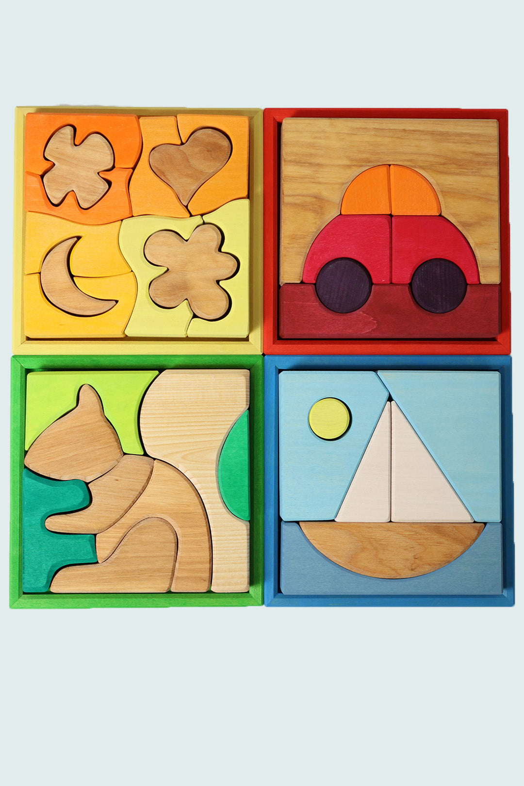 Child in a light playroom stacking Grimm's rainbow pieces and other wooden toys. To Represent Toys section at babipur