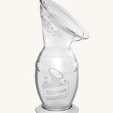 The Haakaa Generation 2 100ml Silicone Breast Pump with Suction Base, on a cream background