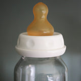 Hevea natural rubber teat on a glass baby bottle.