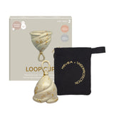Hevea LOOP menstrual cup in cream, in front of its box with a black cotton storage bag.