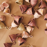 A collection of different sized LOOP menstrual cups in pink and cream.