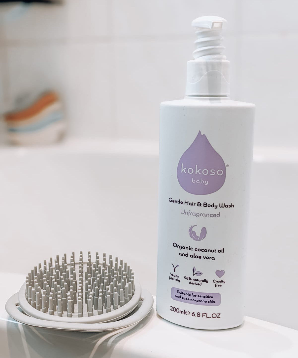 Kokoso unscented organic baby body and hair wash 200ml bottle standing on the side of the bath. Bottle available at Babipur.
