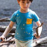 A child outside playing and wearing the LGR Dawn Organic T-Shirt & Jogger Playset