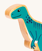 A close up of the chunky wooden Lanka Kade Green Eotyrannus dinosaur figure available at Babipur.