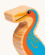 A close up of the chunky wooden Lanka Kade orange blue Hesperornis dinosaur figure available at Babipur.