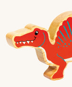 A close up of the chunky wooden Lanka Kade red Spinosaurus figure available at Babipur.