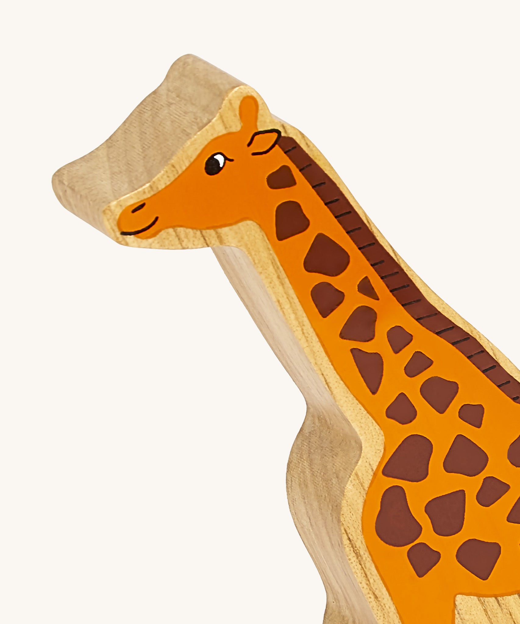 A close up of the chunky wooden Lanka Kade orange giraffe animal figure available at Babipur showing its facial features