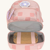 The inside of the Lassig kids mini rose pattern party backpack showing a lunchbox inside the bottom compartment.