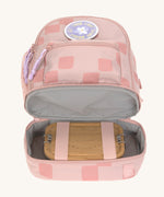The inside of the Lassig kids mini rose pattern party backpack showing a lunchbox inside the bottom compartment.